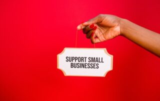 JRB Team - Best places to advertise your local business online - A person holding a sign that says “Support small businesses”