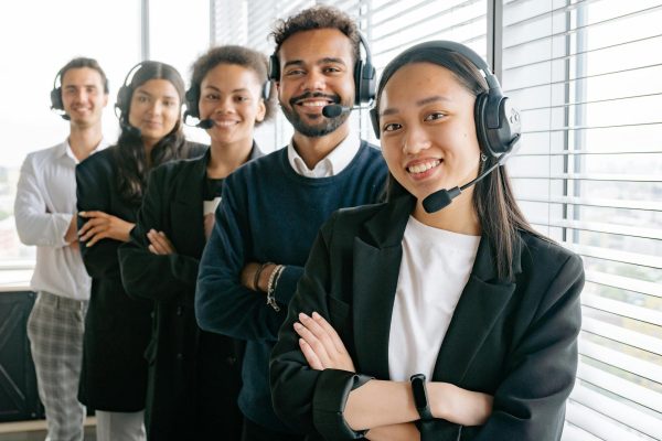 JRB Team Communication - A customer service team standing and smiling.